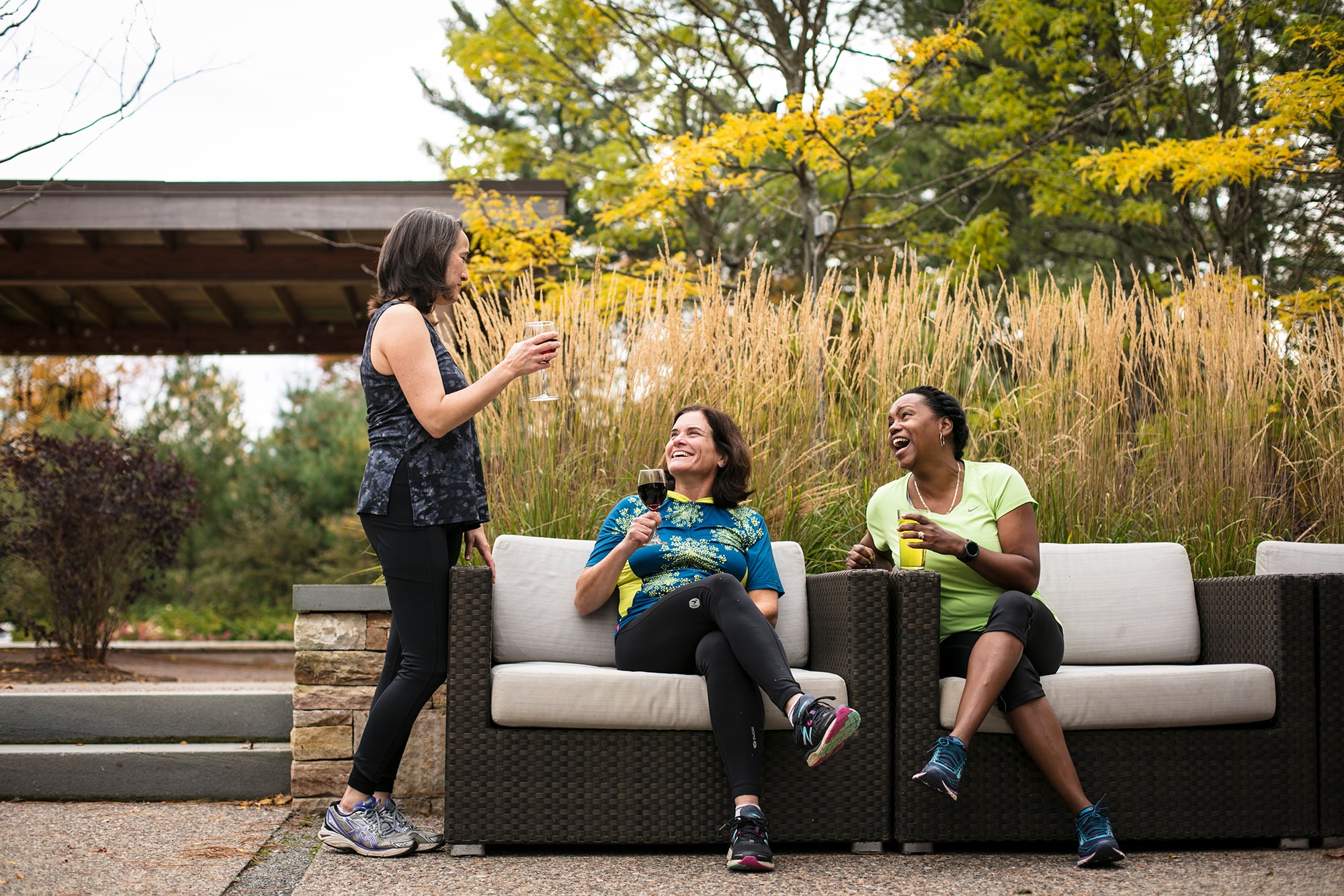 Three women drinking wine and laughing